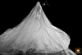 The bride’s father leads her into the wedding ceremony at a hotel in Taiyuan, Shanxi, China, her flowing gown filling the frame